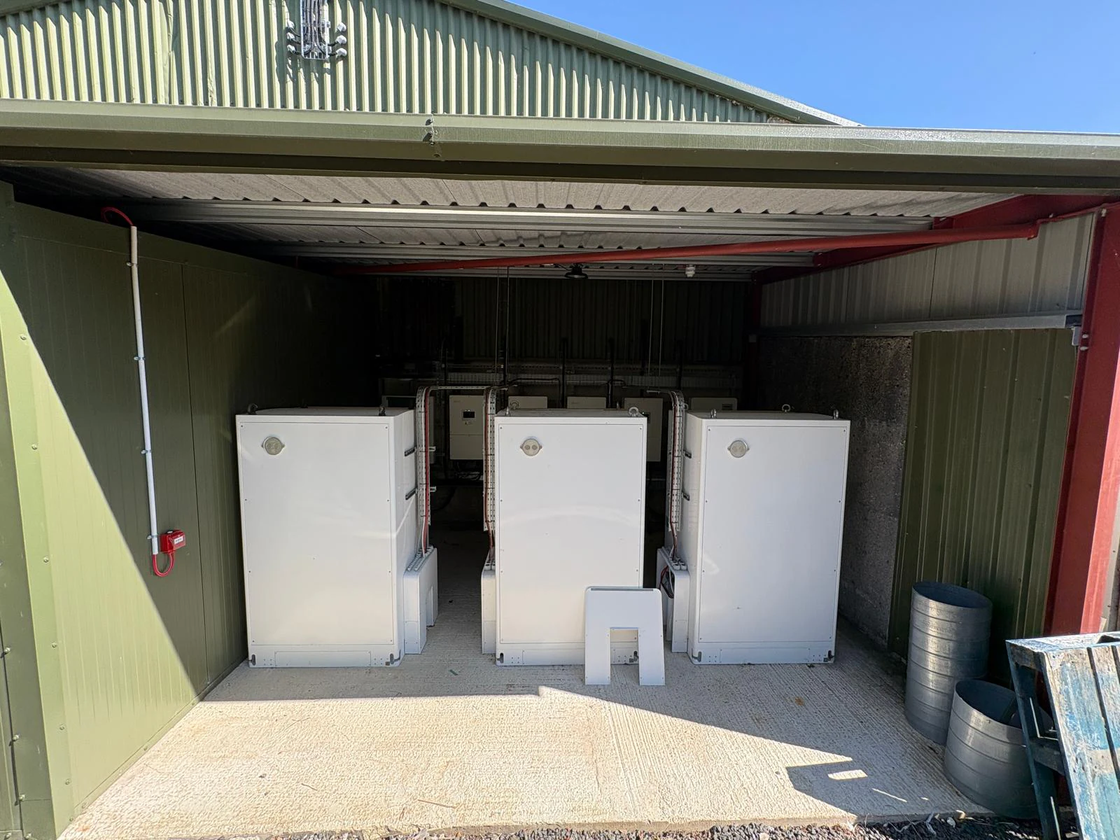 Three battery storage cabinets installed in a covered bay at Annie’s Foods