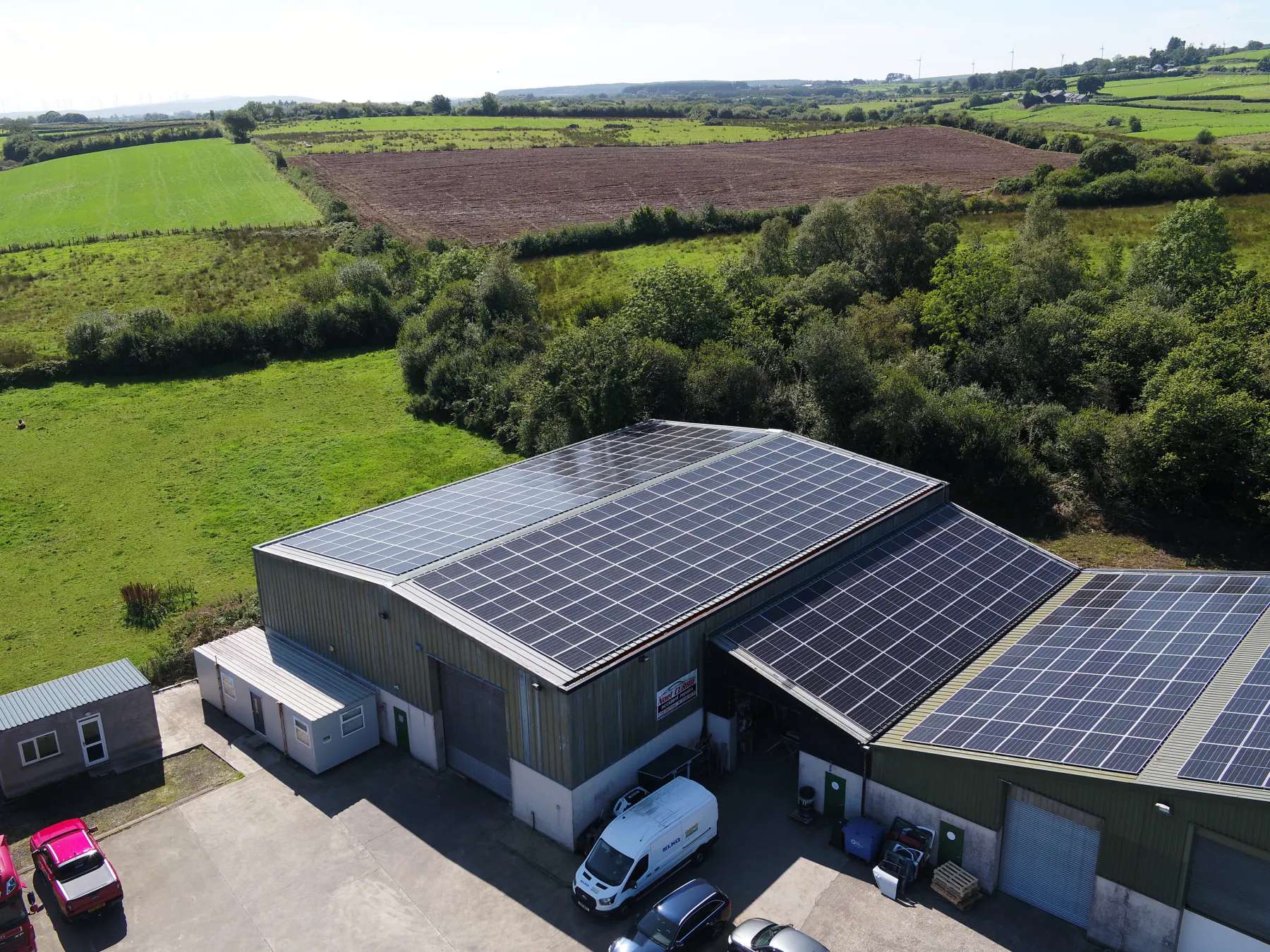 Aerial view of solar panels on Annie’s Foods’ roof, with fields behind