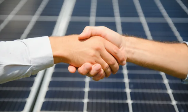 two-people-having-a-shaking-hands-against-solar-pa-2023-11-27-05-35-54-utc