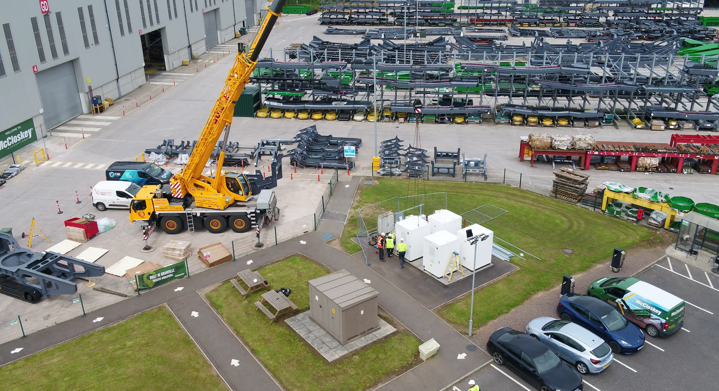 Crane lifting battery storage cabinets into place at McCloskey International (photo 3 of 4)