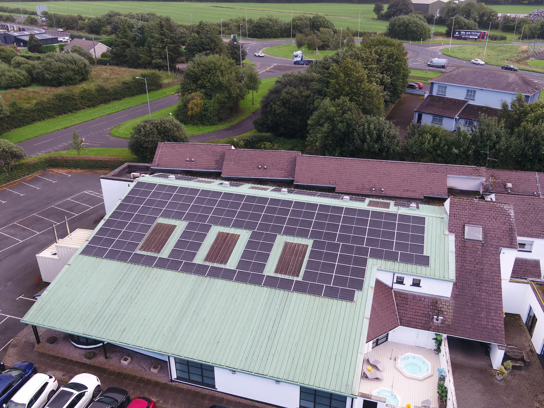 Aerial view of the White Horse Hotel with rooftop solar and surrounding grounds